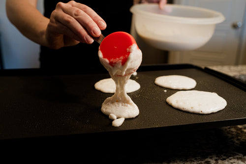 Chef cooking pancakes on a griddle