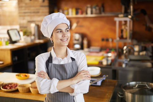 A woman chef in a café with an open kitchen 